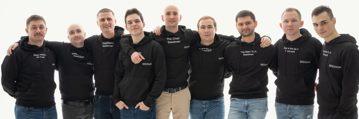The Seedium engineering team, nine people standing arm in arm in Seedium hoodies